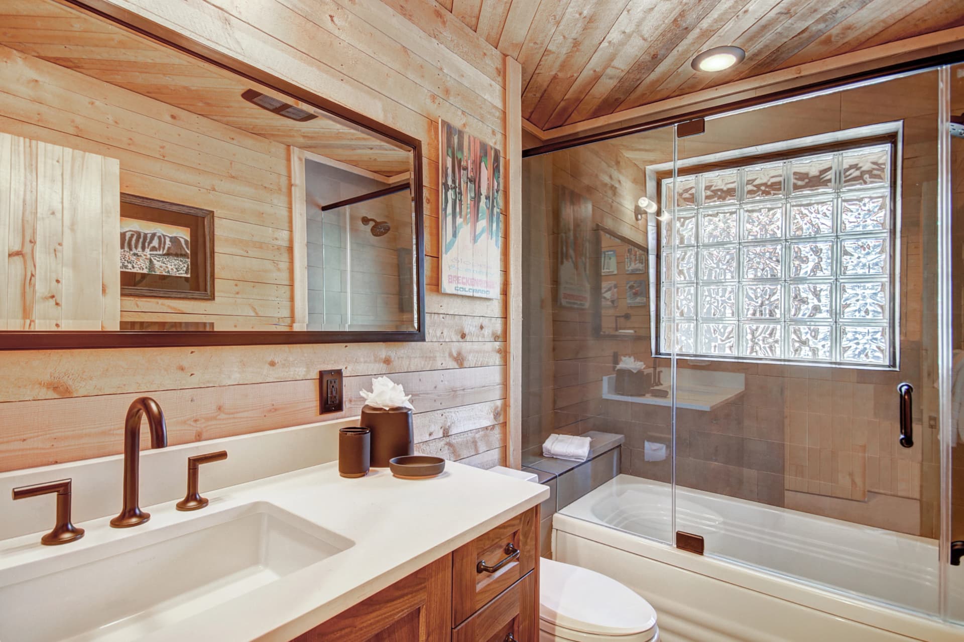 Upper level primary suite private bath with bathtub/shower combination and 1 sink - Arrow Darrow Breckenridge Vacation Rental
